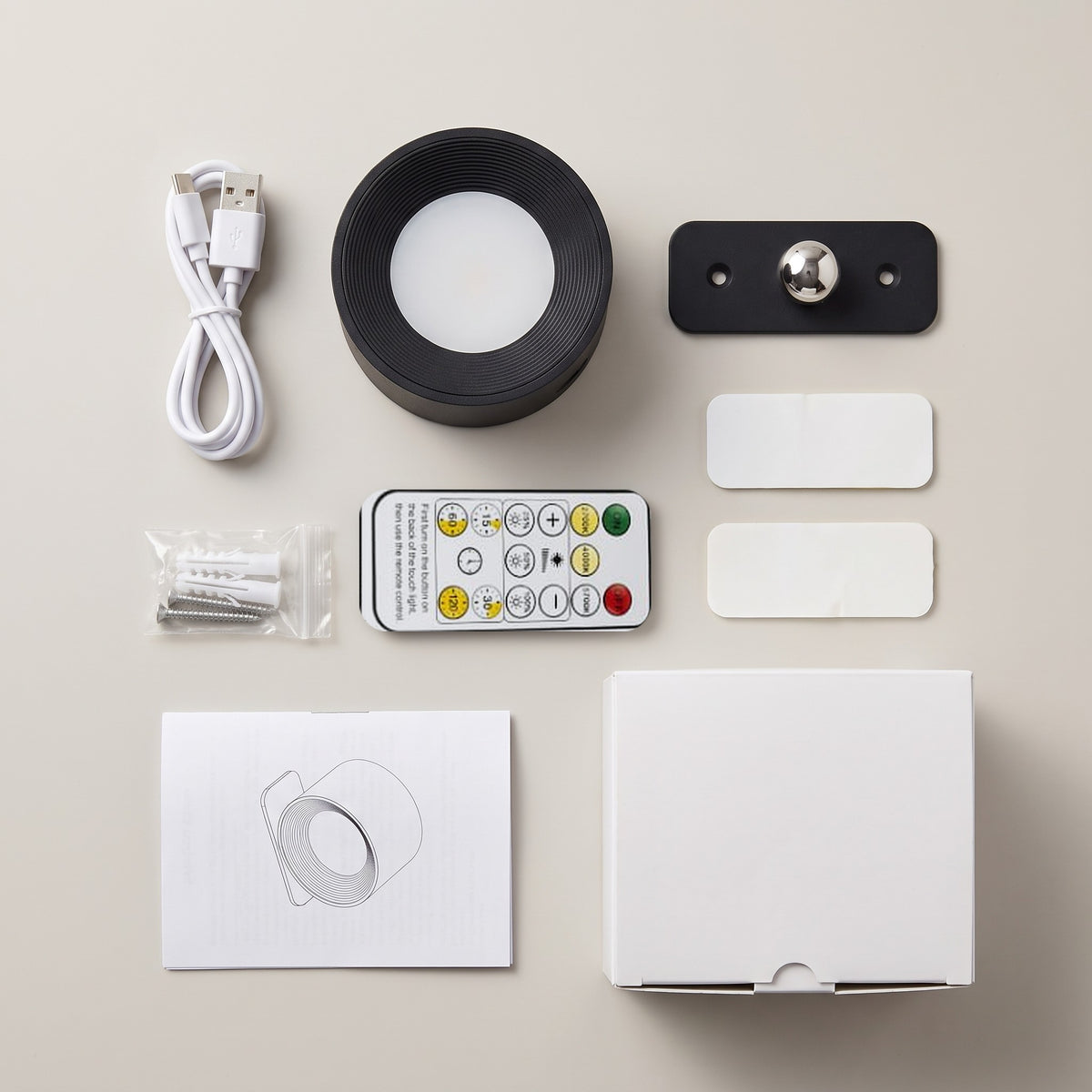 Everything in the Nook lamp box: lamp, magnetic mount, remote, USB-C cable, 2 adhesive pads, screws and wall plugs, manual