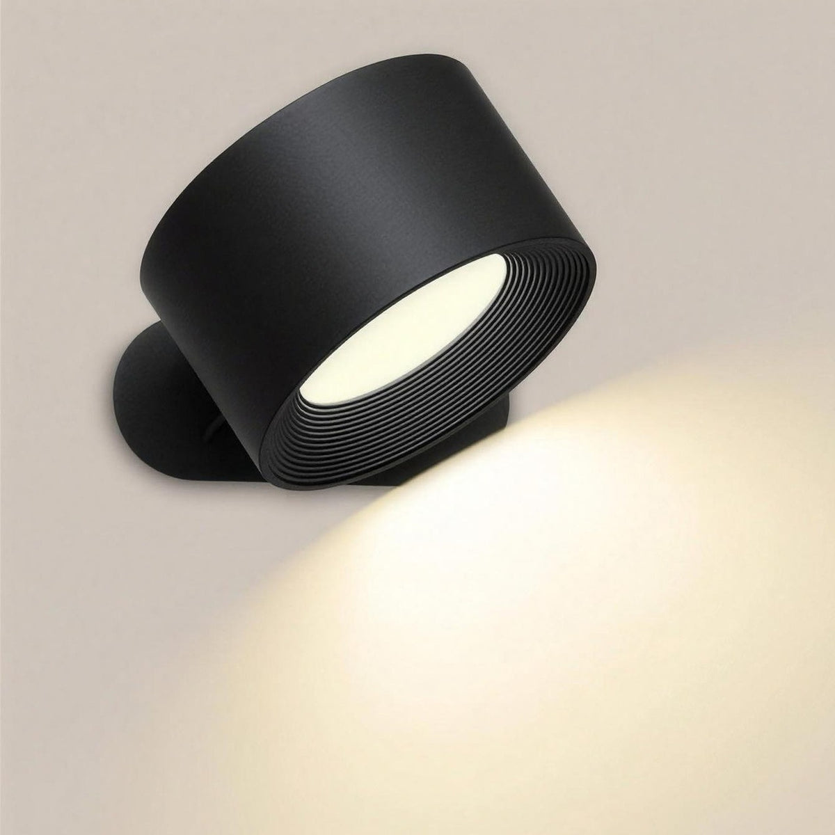 Nook cordless wall lamp in black, switched on, on its magnetic wall mount