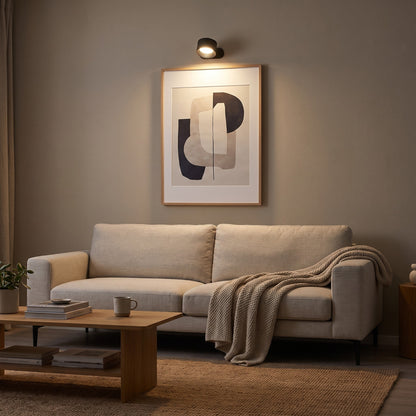 Black Nook lamp lighting a framed print above a sofa