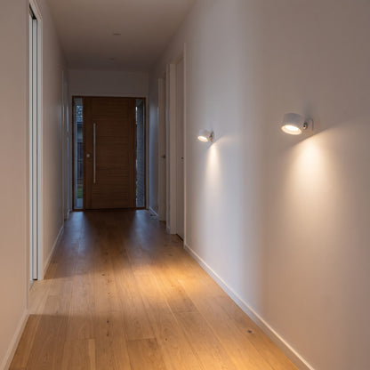 Two white Nook lamps lighting a hallway
