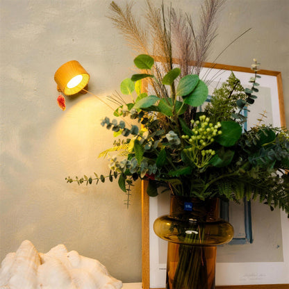 Wood Nook lamp lighting a vase of greenery and dried grasses