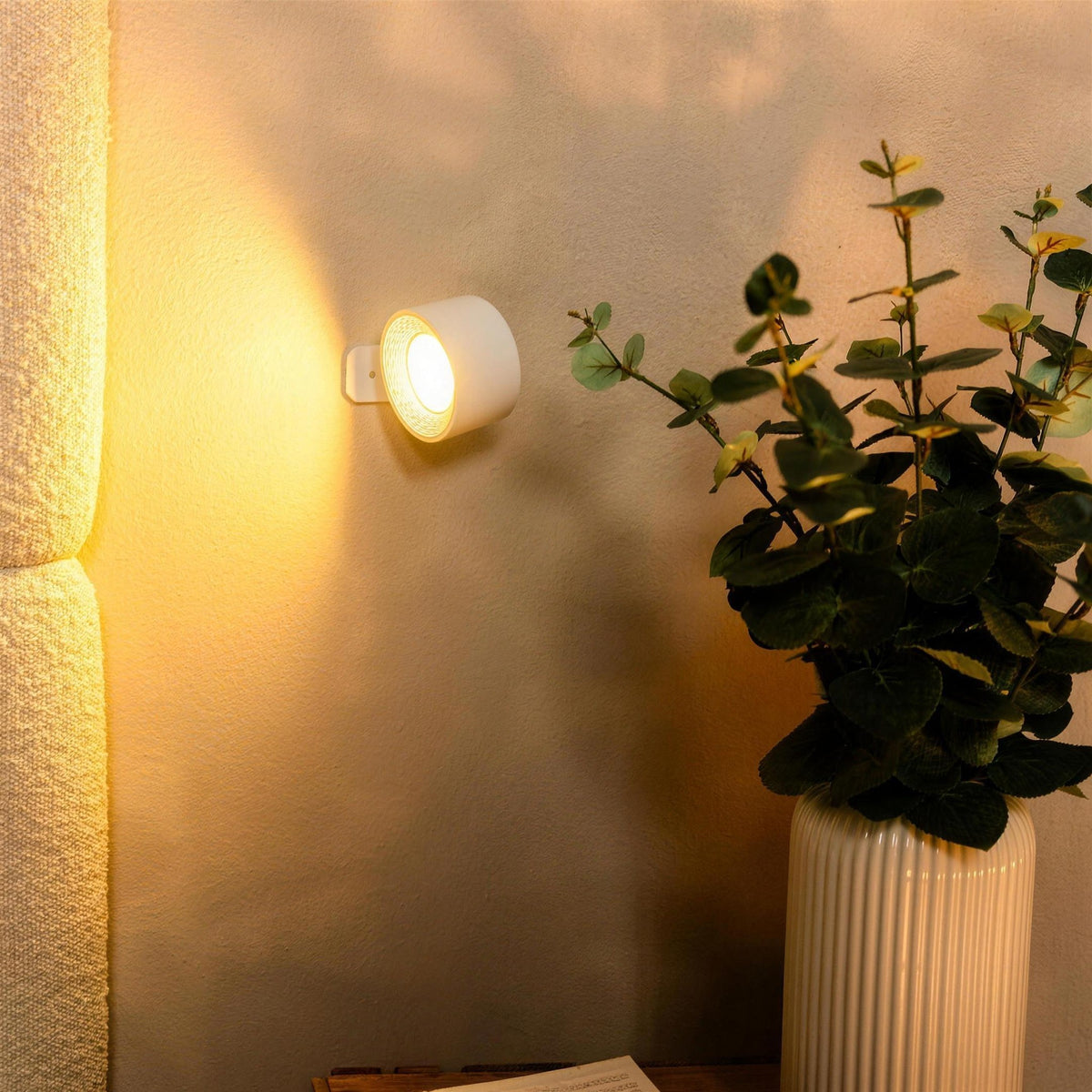 White Nook lamp casting warm light next to a potted plant