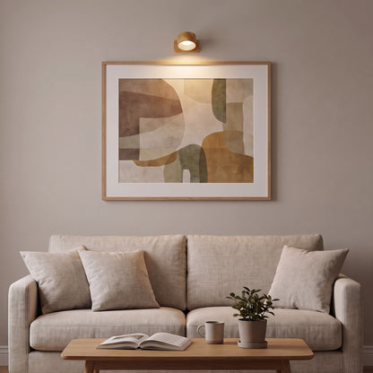 Wood Nook lamp lighting a framed print above a sofa