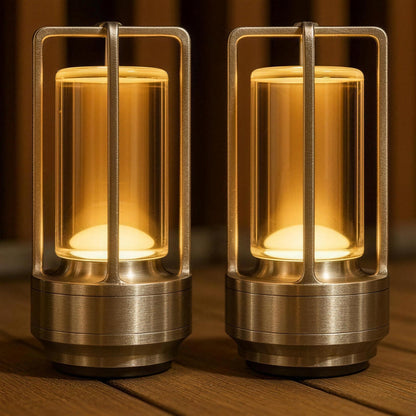 Two Premium aluminium Nook Glow Lanterns with a brushed metal frame, lit in amber