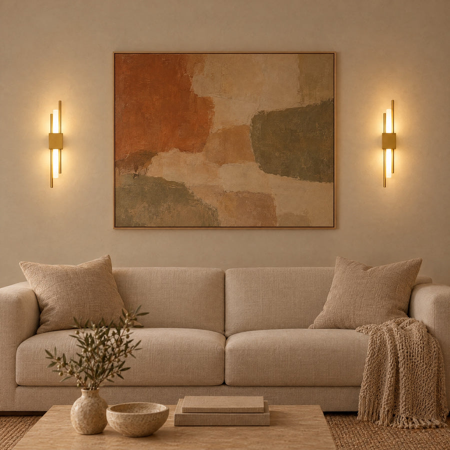 Illustration: A pair of gold sconces either side of a large canvas.