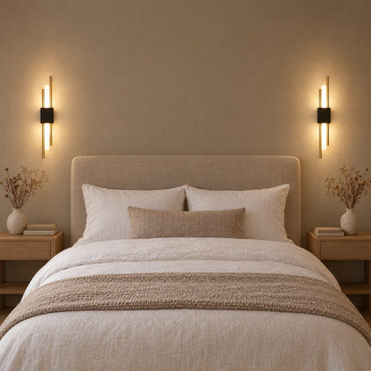 A pair of black and gold Nook Duo Sconces either side of a bed