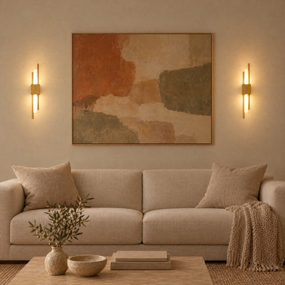 A pair of gold Nook Duo Sconces either side of a large canvas
